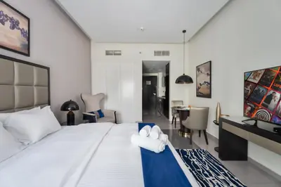 a bedroom with a large white bed with towels on it at Downtown Dubai Studio Apartment - High floor in Dubai