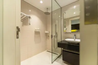 a bathroom with a glass shower and a sink at Downtown Dubai Studio Apartment - High floor in Dubai