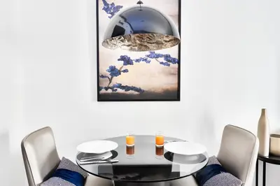 a dining room with a glass table and chairs at Downtown Dubai Studio Apartment - High floor in Dubai
