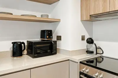 a microwave oven sitting on top of a kitchen counter at BLVD - Stylish Missoni Stay - Canal View in Dubai