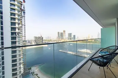 a balcony with a view of a body of water at Lux and Spacious 1 Bed with Beach in Dubai