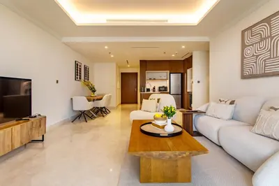 a living room with a couch and a table at Lux and Spacious 1 Bed with Beach in Dubai