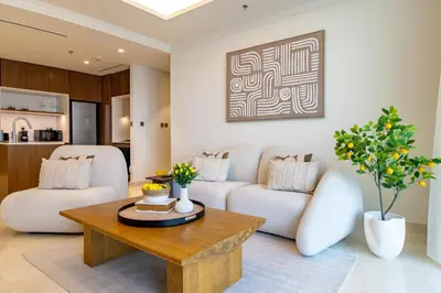 a living room with a couch and a table at Lux and Spacious 1 Bed with Beach in Dubai