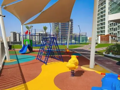 a play area with a playground with a play equipment at Luxury Studio with Gym, Pool & Badminton Court in Dubai