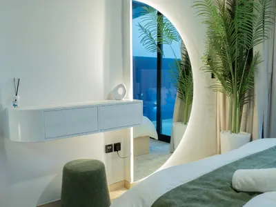a bedroom with a bed and a mirror at Binghatti Crest in Dubai