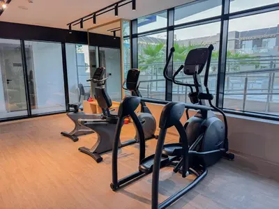 a gym with treadmills and ellipticals in a building at Binghatti Crest in Dubai