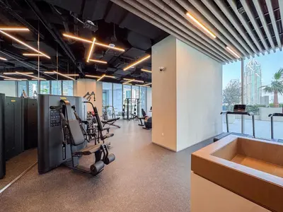 an office with a gym with exercise equipment and a sink at Incredibly Elegant 1BDR with full Marina Views in Dubai