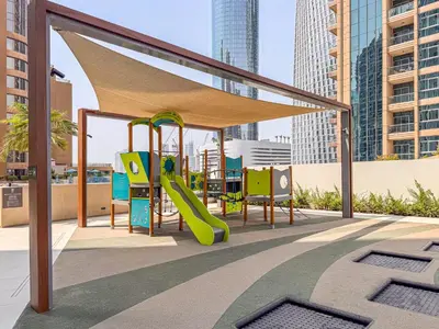a play area with a slide and a playground at Incredibly Elegant 1BDR with full Marina Views in Dubai