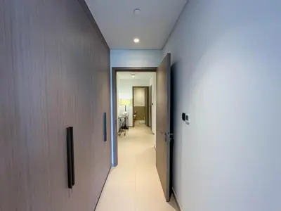 a hallway leading to a room with a door at Beautiful 2BR with Burj Khalifa Views in Dubai
