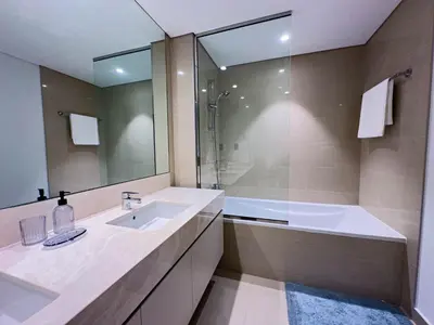 a bathroom with a sink and a shower and a tub at Beautiful 2BR with Burj Khalifa Views in Dubai