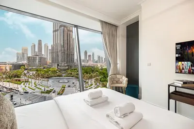 a hotel room with a view of a city at Luxury Burj Vista Suites by Mystique - Breathtaking Burj Khalifa Views in Dubai