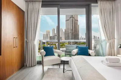 a hotel room with a bed and a large window at Luxury Burj Vista Suites by Mystique - Breathtaking Burj Khalifa Views in Dubai
