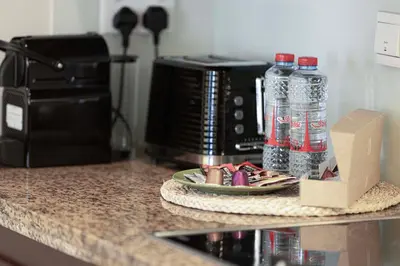 a counter top with bottles of water and a microwave at Cozy Studio Near Burj Khalifa Sleeps 3 in Dubai