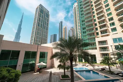 a pool in a city with tall buildings at Cozy Studio Near Burj Khalifa Sleeps 3 in Dubai