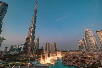 a view of a city with a fountain and skyscrapers at Stunning 2BR with Panoramic Burj & Fountain view in Dubai