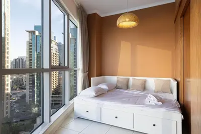 a bed in a room with a large window at Stunning 2BR with Panoramic Burj & Fountain view in Dubai
