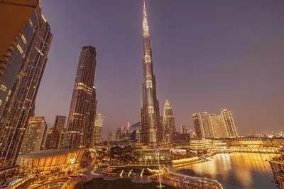 a view of a city at night with the shard at Stunning 2BR with Panoramic Burj & Fountain view in Dubai