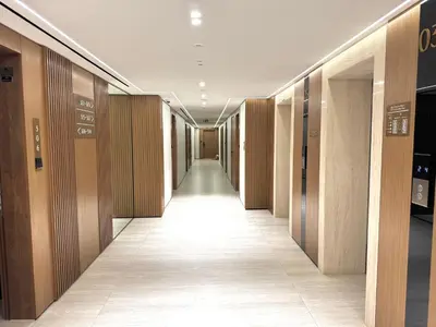 a corridor of a building with wooden walls at Binghatti Galaxy 2 in Dubai