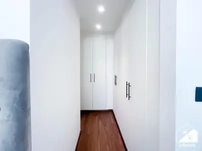 a hallway with white doors and a wooden floor at Stylish JVC Duplex l Gym, Pool & Parking in Dubai