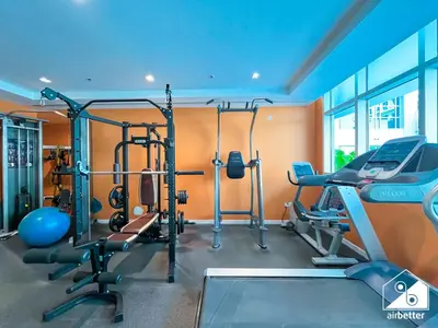 a gym with several tread machines and a treadmill at Stylish JVC Duplex l Gym, Pool & Parking in Dubai