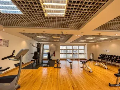 a gym with treadmills and exercise equipment in a room at Cozy Studio with Sofa bed beside DMCC Metro & Dubai Marina in Dubai