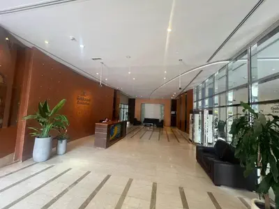 an office lobby with a couch and a desk at Cozy Studio with Sofa bed beside DMCC Metro & Dubai Marina in Dubai