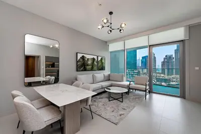 a living room with a couch and a table at Exciting 1BR apartment Liv Marina in JBR in Dubai