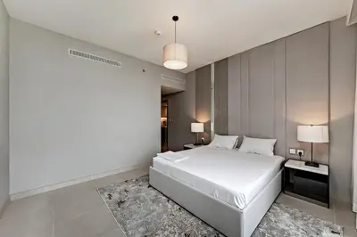 a bedroom with a large white bed in a room at Exciting 1BR apartment Liv Marina in JBR in Dubai