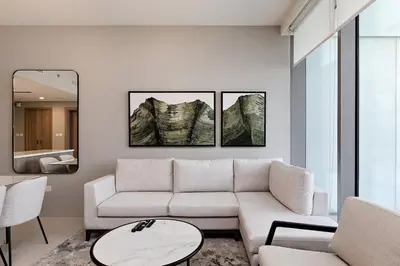 a living room with a white couch and a table at Exciting 1BR apartment Liv Marina in JBR in Dubai