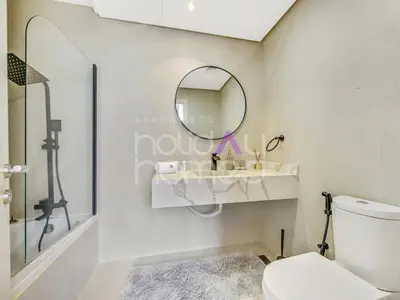 a bathroom with a toilet and a mirror at Modern 2BR Gem Full Golf Views & Pool in Dubai