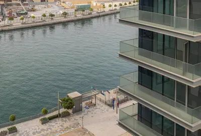 an aerial view of a river next to a building at 2BR plus Maid CF7 B Stylish Stay with Large Balcony in Dubai