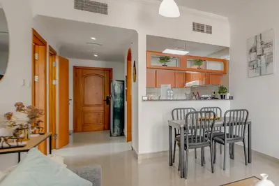 a kitchen and dining room with a table and chairs at Spacious 1BR in Great Location, Manchester Tower, Dubai Marina in Dubai