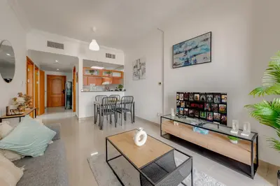 a living room with a couch and a table at Spacious 1BR in Great Location, Manchester Tower, Dubai Marina in Dubai