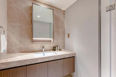 a bathroom with a sink and a mirror at Sea Breeze apartment in Grand Bleu - private Beach in Dubai