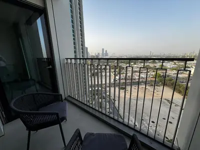 a balcony with chairs and a view of a city at 2min Walk to Dubai Mall - 2BR - Infinity Pool & Gym - Burj Khalifa in Dubai