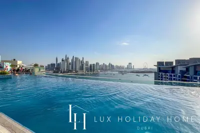 a large swimming pool with a city in the background at LUX The Seven Res Palm Studio in Dubai