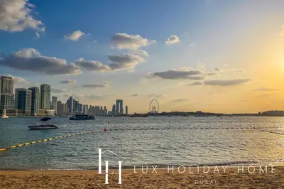 a body of water with a city in the background at LUX The Seven Res Palm Studio in Dubai