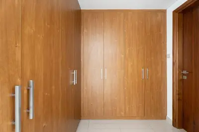 two wooden cabinets in a room with a door at GuestReady - Luxury 2BD w/ balcony | Business Bay in Dubai