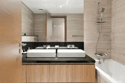 a bathroom with a sink and a tub and a mirror at BLVD - Missoni Canal View - Walk to Dubai Mall in Dubai