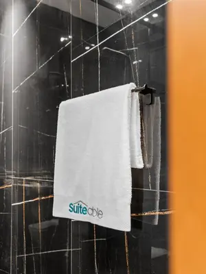 a bathroom with a white towel hanging on a wall at Upscale 2Bedroom with Private Balcony Pool in JVC in Dubai