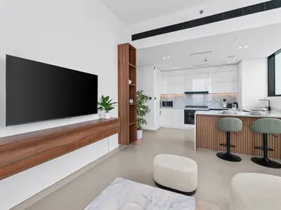 a living room with a flat screen tv on a wall at Upscale 2Bedroom with Private Balcony Pool in JVC in Dubai