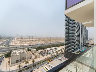 an aerial view of a city with a tall building at Upscale 2Bedroom with Private Balcony Pool in JVC in Dubai