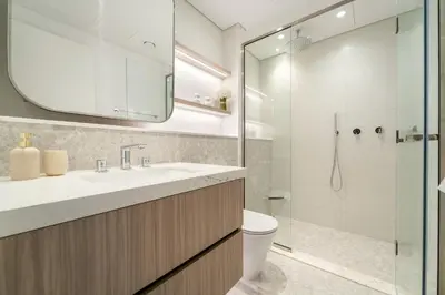 a bathroom with a toilet and a sink and a shower at 1BR Luxury Stay in Sobha Hartland in Dubai