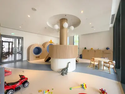a room with a toy car and a table at 1BR Luxury Stay in Sobha Hartland in Dubai