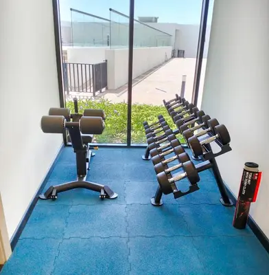 a gym with two rows of chairs in front of a window at EasyGo- Comfy, near metro, Easy Access to City Roads in Dubai