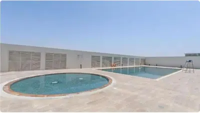 a large swimming pool in the middle of a building at EasyGo- Comfy, near metro, Easy Access to City Roads in Dubai