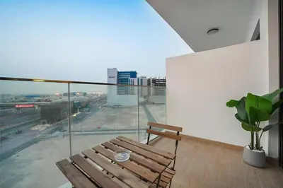 a balcony with a wooden bench and a view of a city at EasyGo- Comfy, near metro, Easy Access to City Roads in Dubai