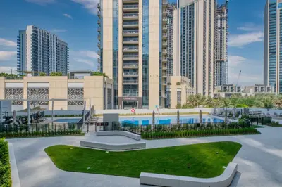 a building with a pool in front of tall buildings at Relax & Unwind with Dubai Creek Vibes in Dubai