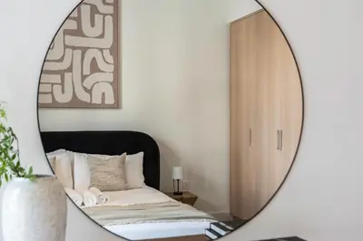a bedroom with a bed and a mirror at Relax & Unwind with Dubai Creek Vibes in Dubai
