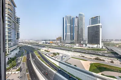 a highway in a city with tall buildings at Waves - Stylish Studio Near Downtown Dubai in Dubai